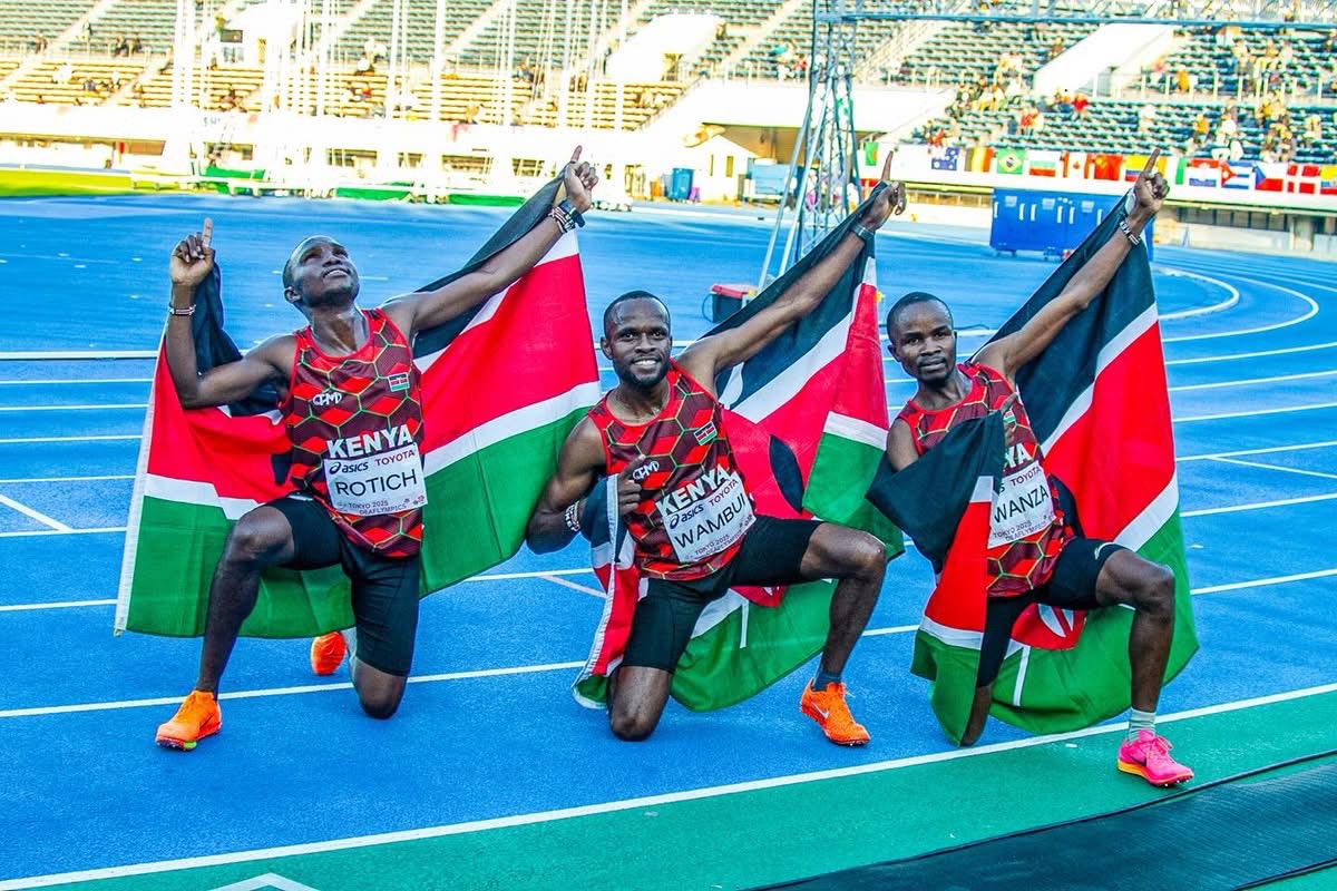 three Kenyan athletes with Kenyan flags